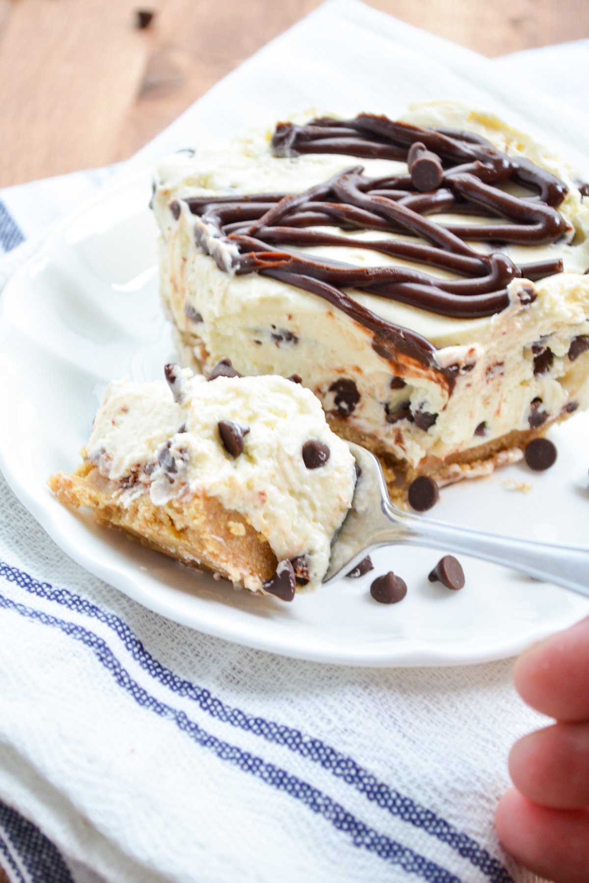 A fork taking a piece of no bake chocolate chip cheesecake