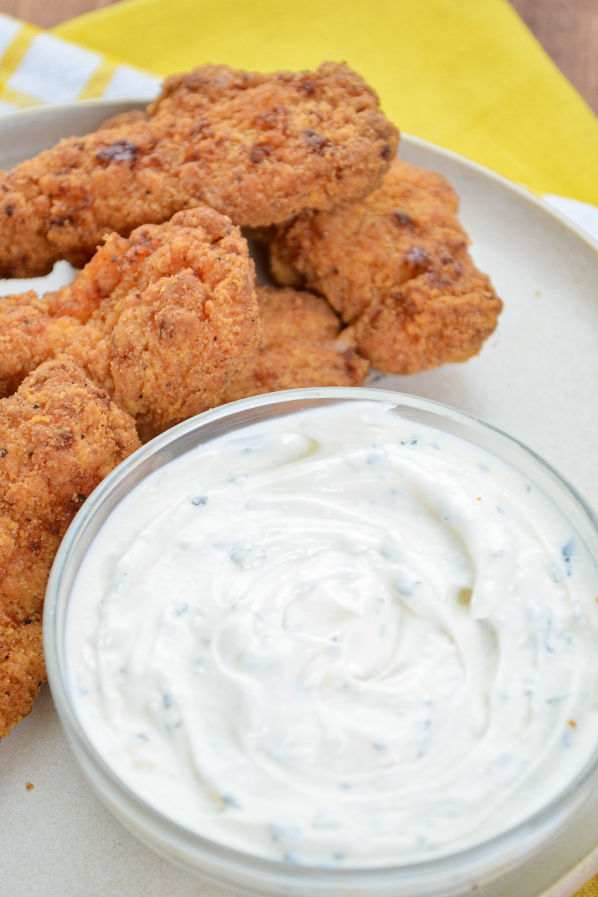 A serving of fried chicken tenders with ranch dip.