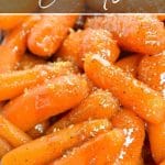 A close up of carrots topped with a glaze and brown sugar.