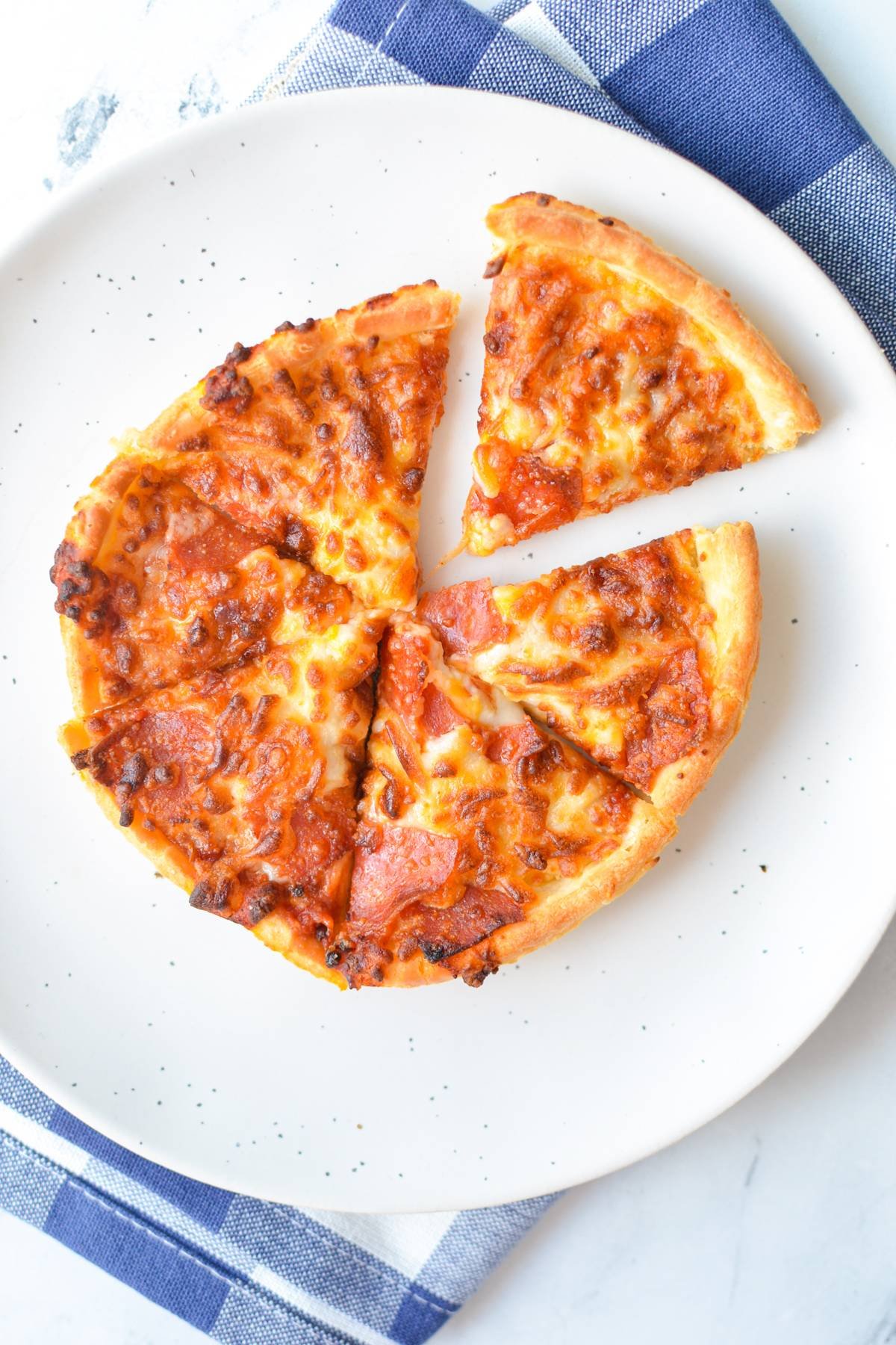 A mini pizza cut into 6 slices.