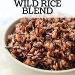 A bowl of wild rice blend on an off white napkin.