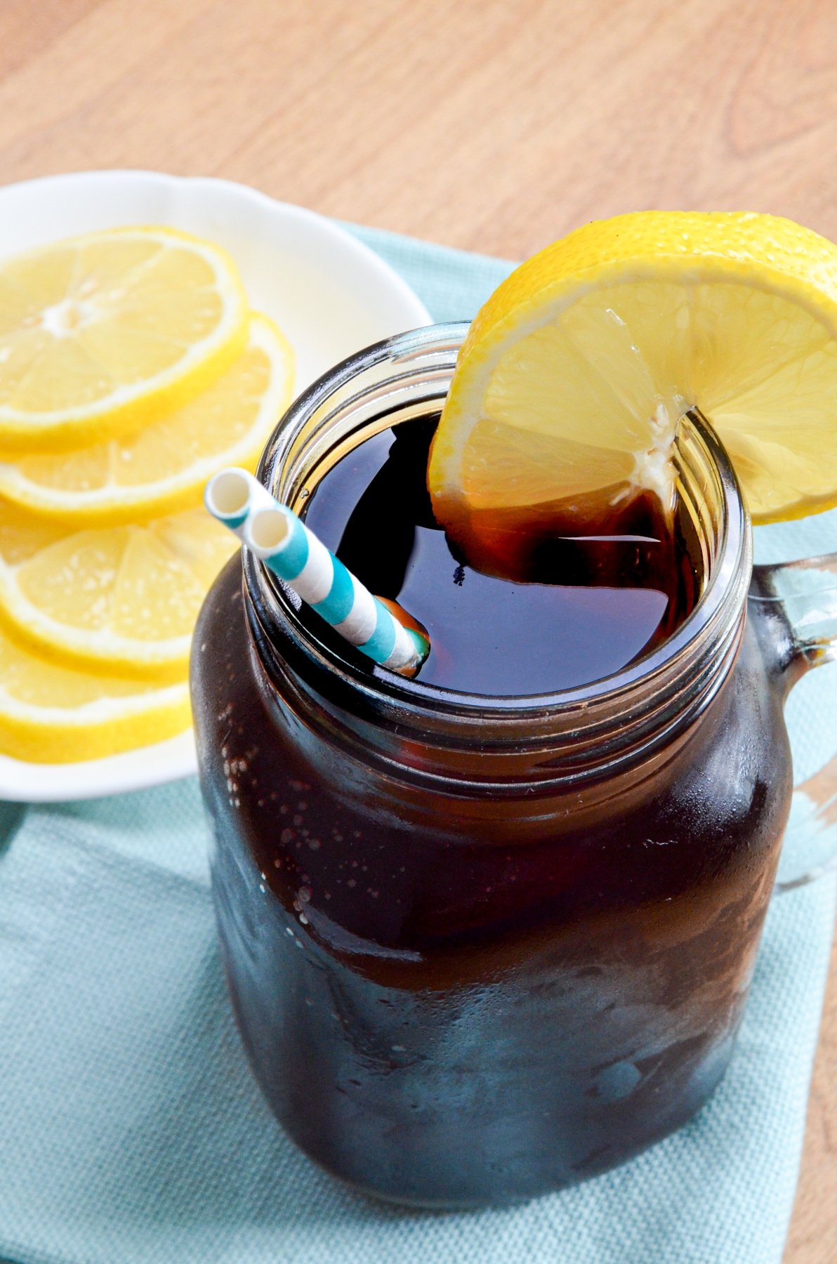 A glass of iced sweet tea, garnished with a lemon slice.