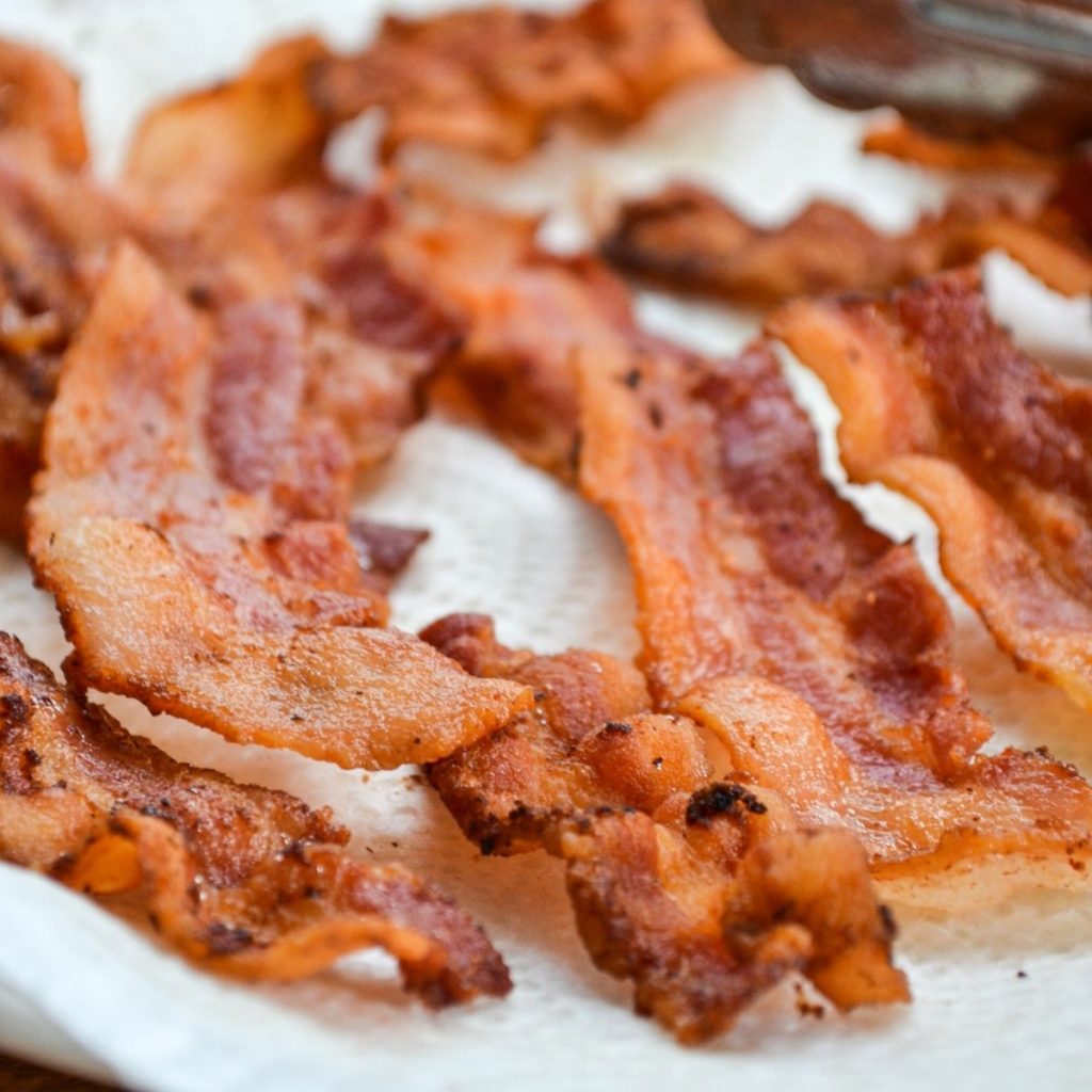 A plate full of draining crispy bacon