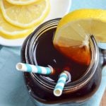 A glass of iced tea, garnished with a lemon slice.