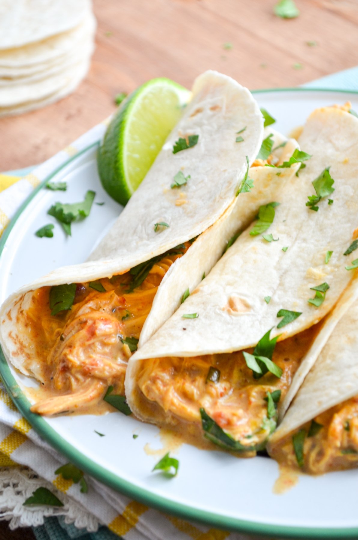 Queso Chicken Tacos, garnished with lime and cilantro.