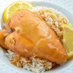 Slow cooker lemonade chicken, garnished with lemon wedges.