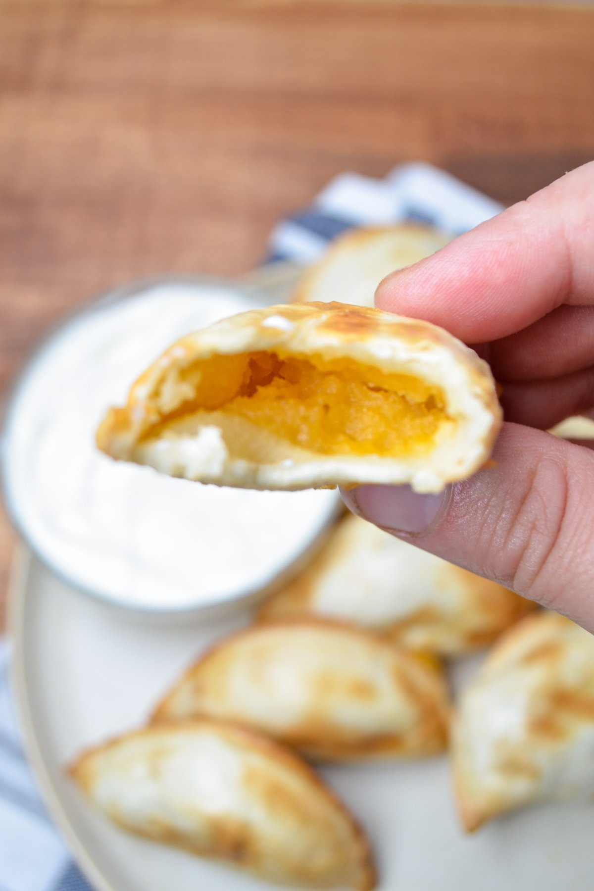 A pierogi, in half, with a cheesy potato filling.