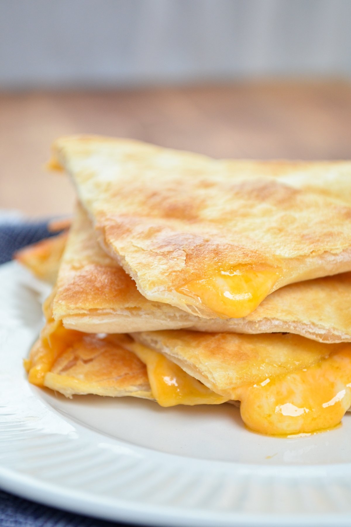 A stack of three air fryer cheese quesadilla triangles.