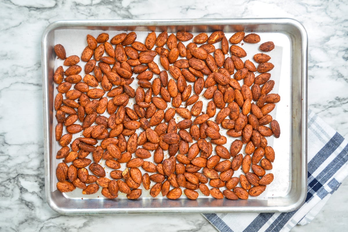 A sheet pan of roasted almonds, cooling from the air fryer.