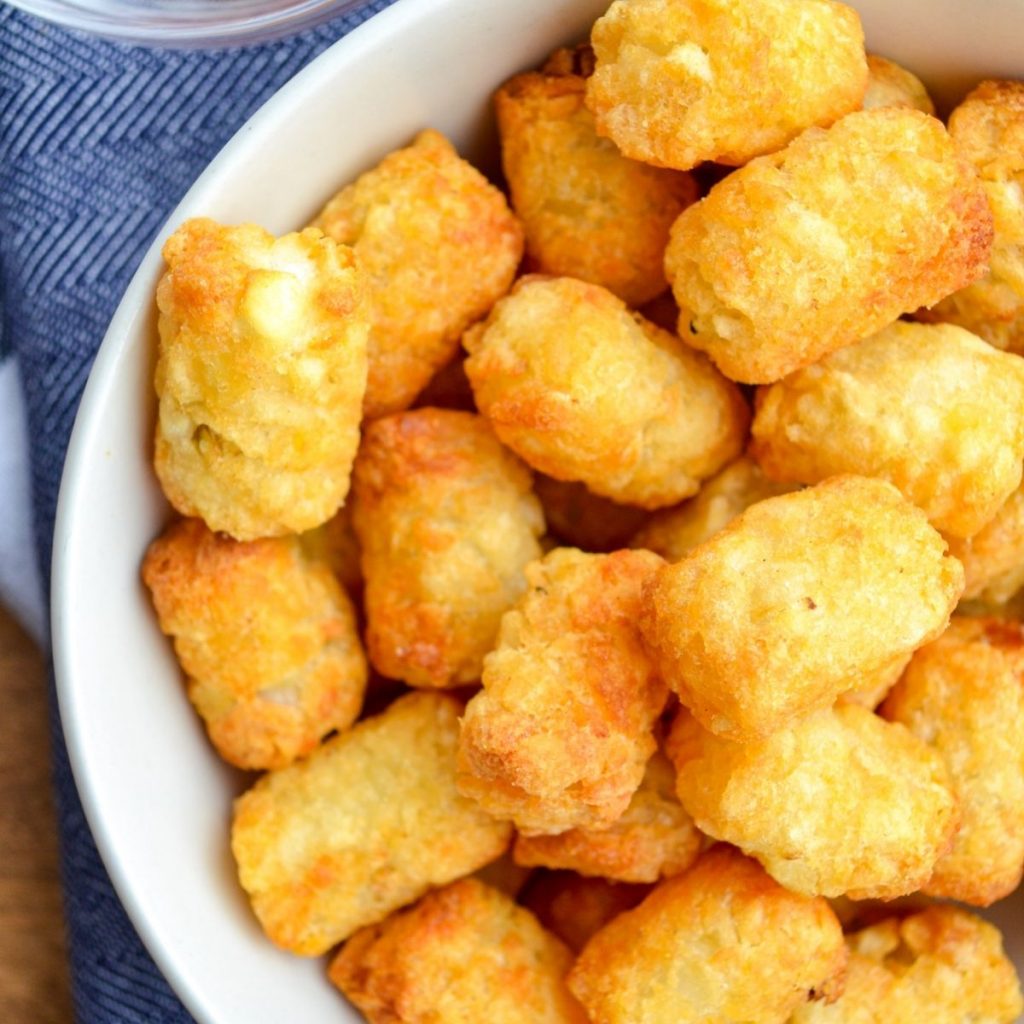 A bowl of cooked tater tots.