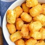 A bowl of cooked tater tots.