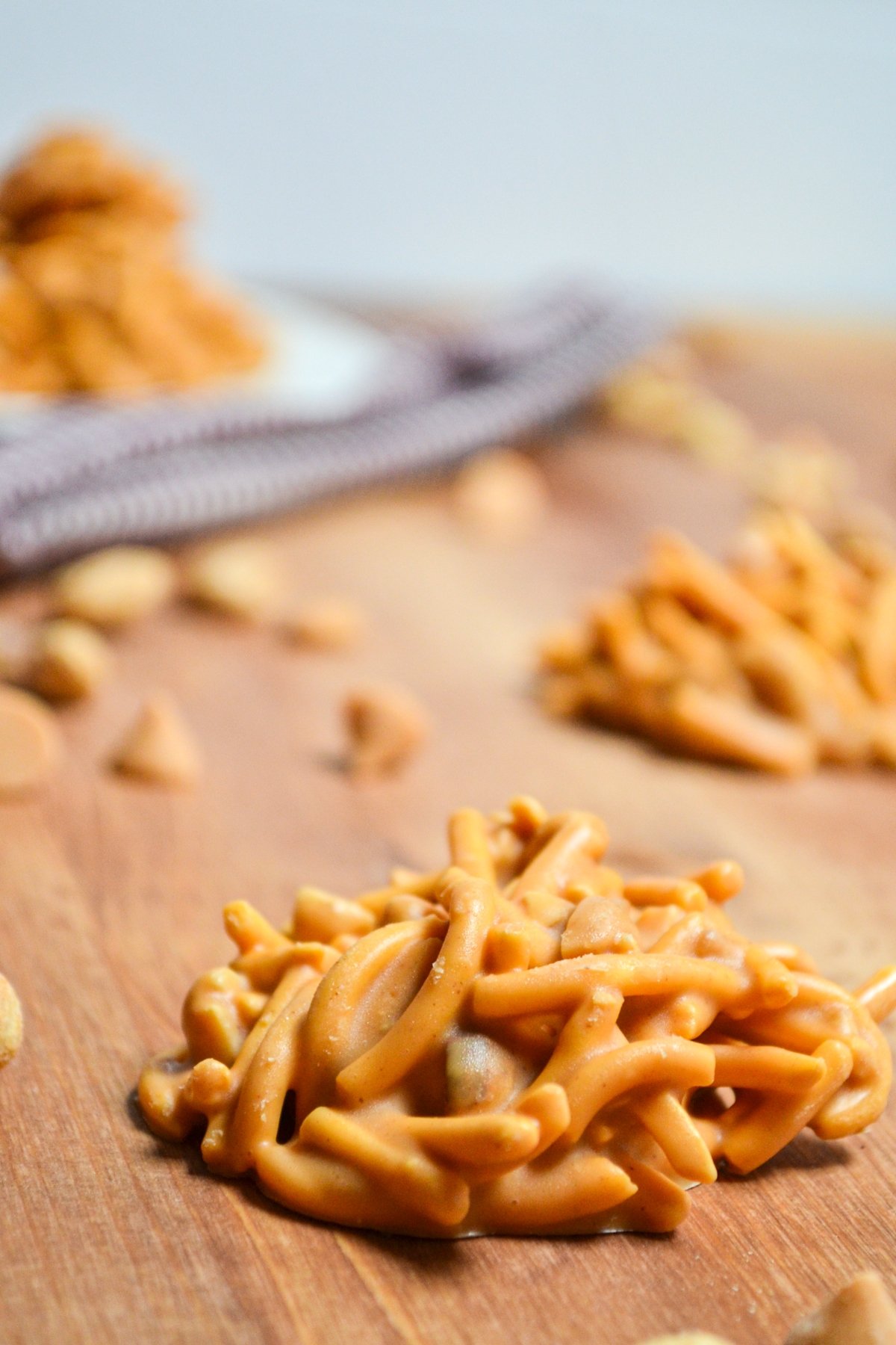 Butterscotch haystack cookies, laying on a wood surface.