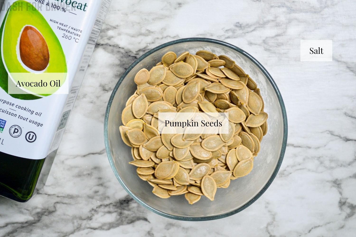 The ingredients needed to get started with roasting pumpkin seeds. You will need salt, cleaned and soaked pumpkin seeds, and salt.