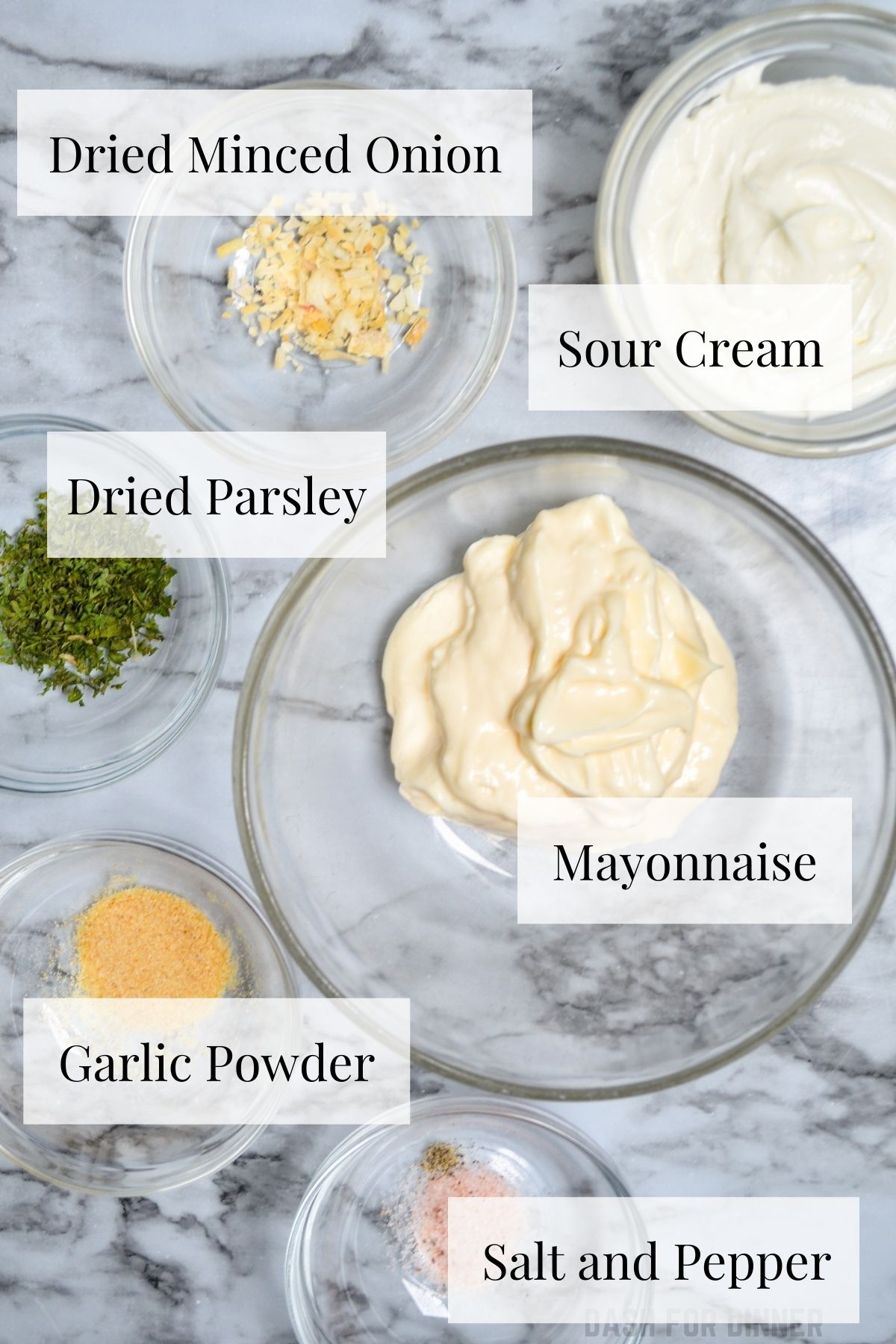 The ingredients needed to make ranch dip: mayonnaise, sour cream, dried minced onion, dried parsley, garlic powder, salt, and pepper.
