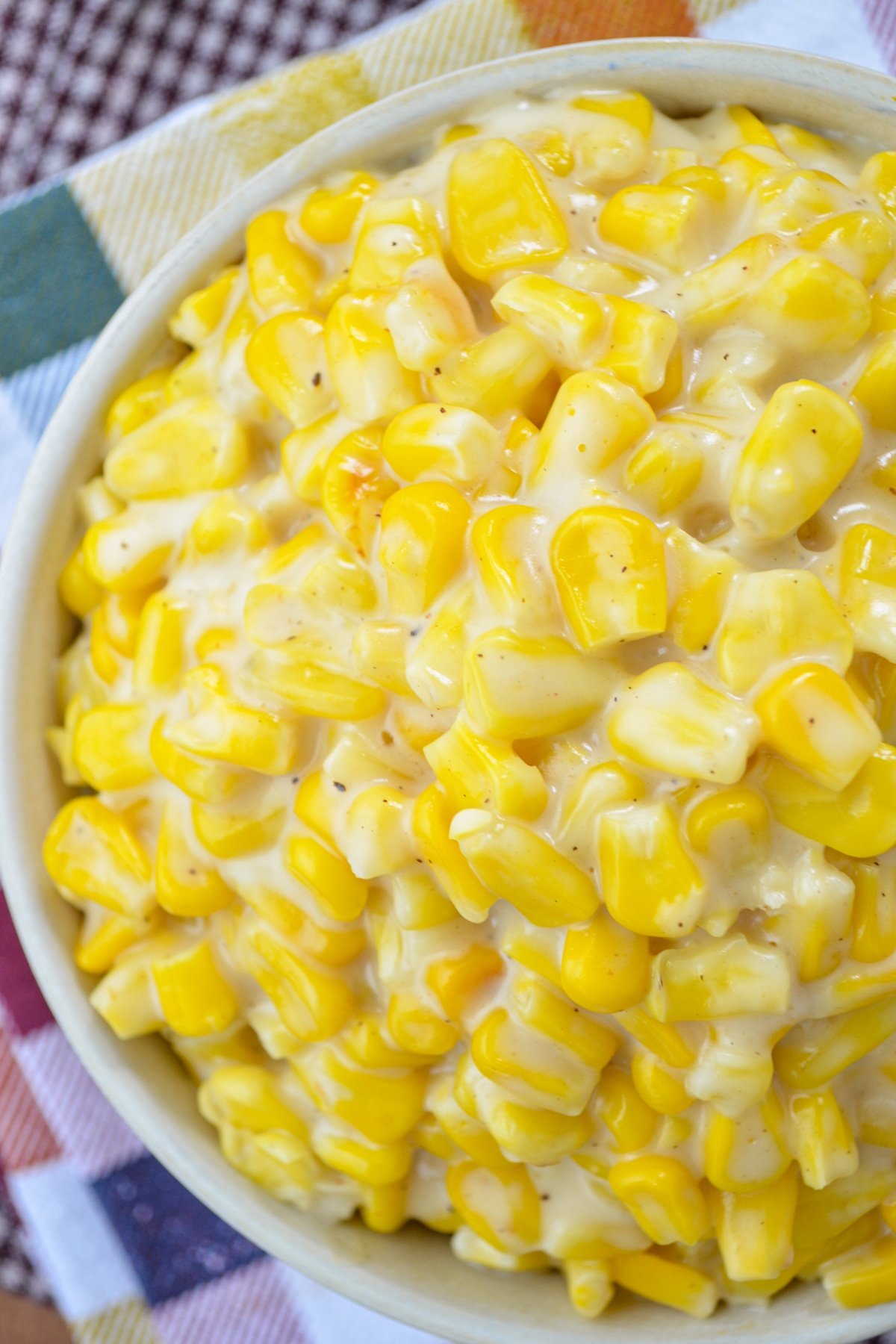 A close up of a bowl of creamed corn.