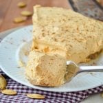 A slice of pumpkin fluff pie, with a fork sinking down into it for a bite.