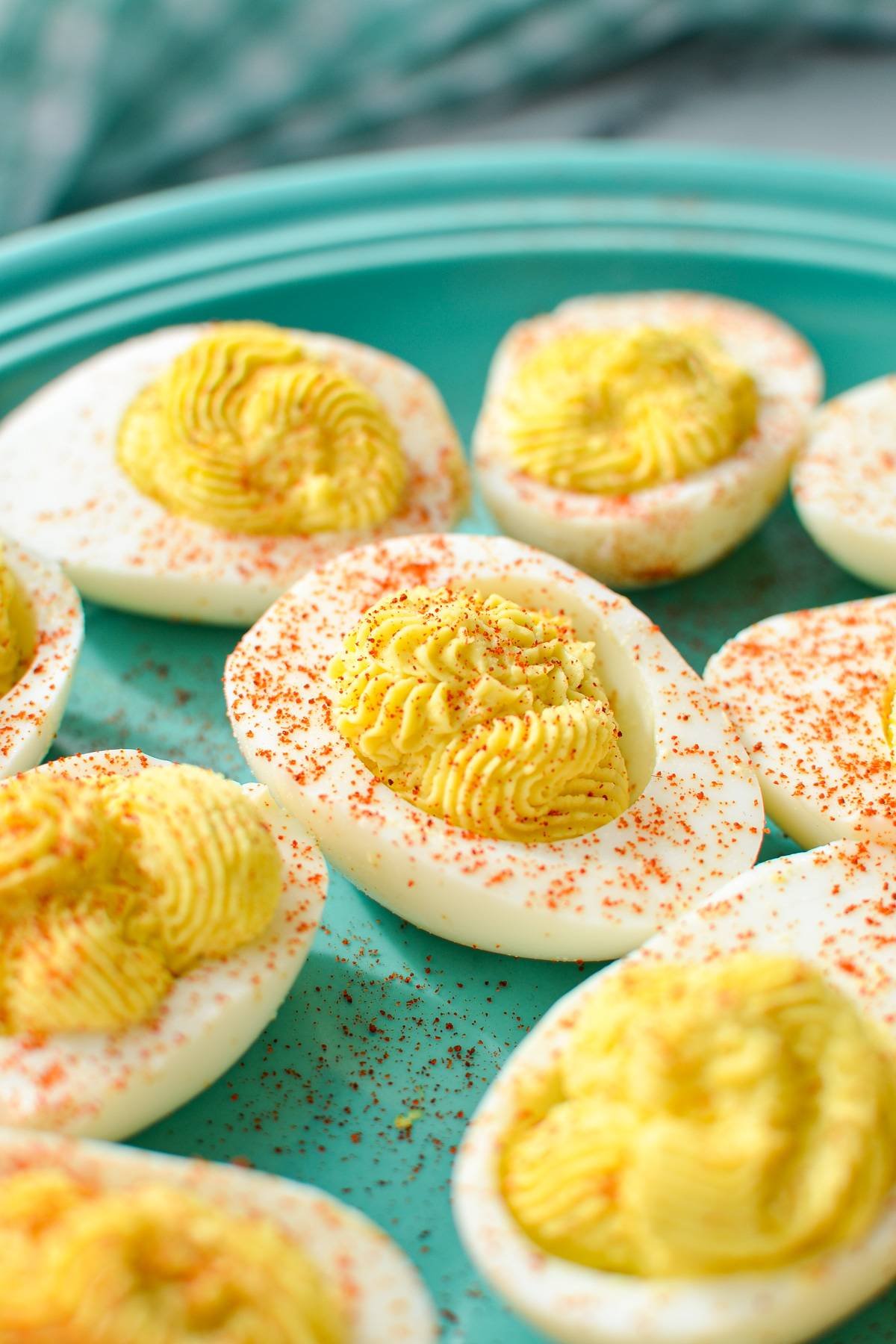 A plate of deviled eggs, sprinkled with paprika.