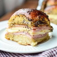 A ham and cheese baked sandwich on a plate.