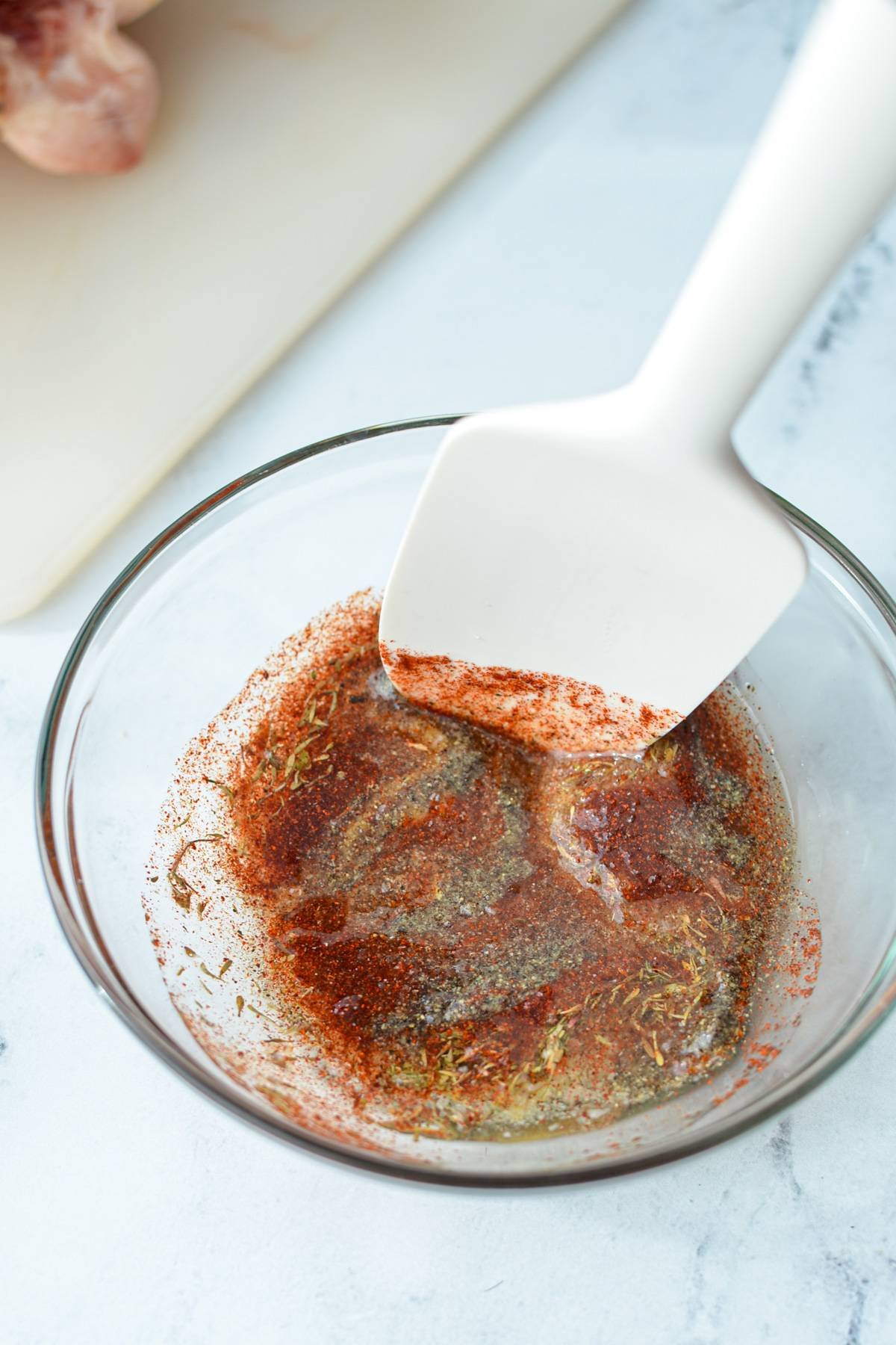 A small bowl of seasonings, blended with oil.