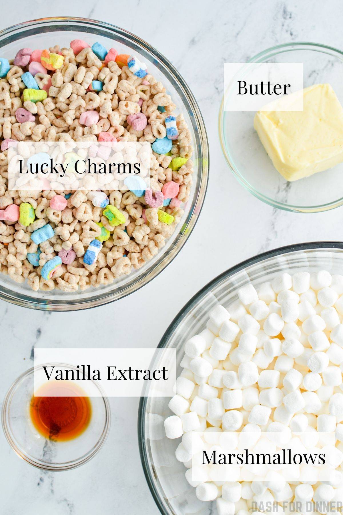 The ingredients needed to make lucky charms treats: marshmallows, lucky charms, butter, vanilla extract.