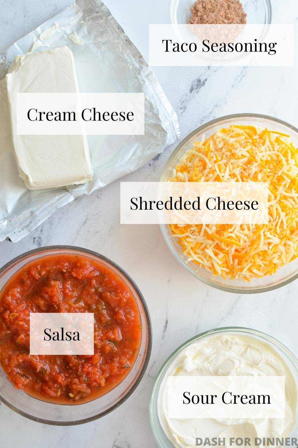 The ingredients needed to make a layered taco dip: cream cheese, salsa, cheese, sour cream, and taco seasoning.