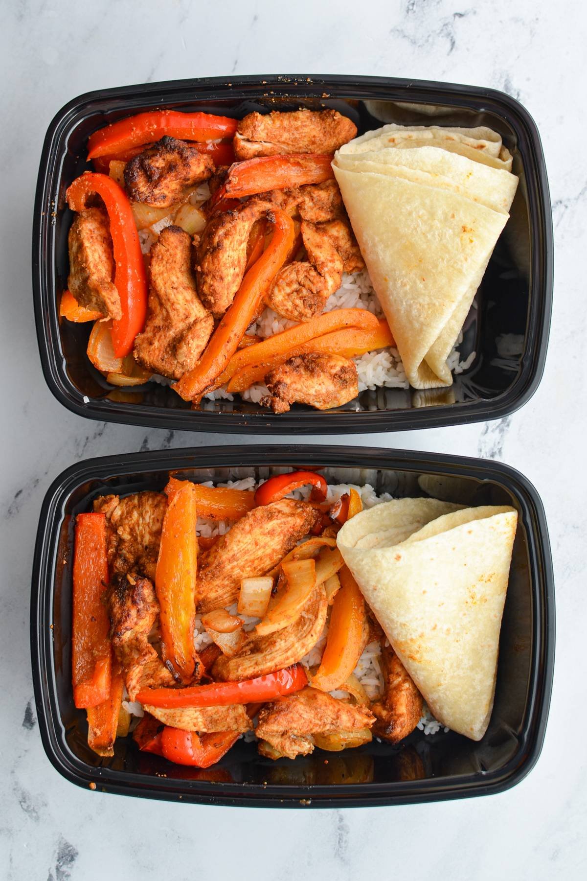 Meal prep containers with chicken fajita filling and tortillas.