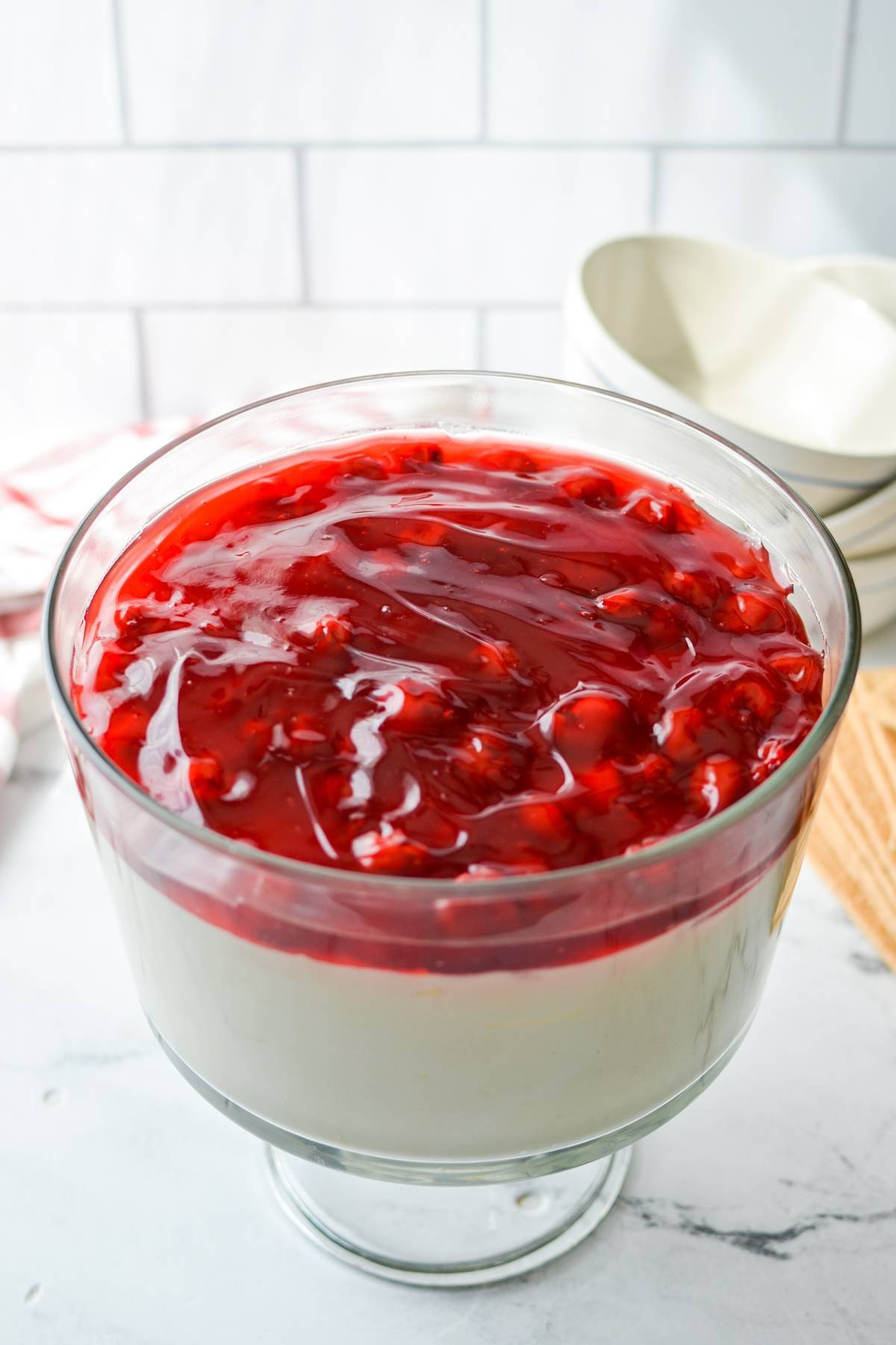 A trifle dish full of cheesecake salad.