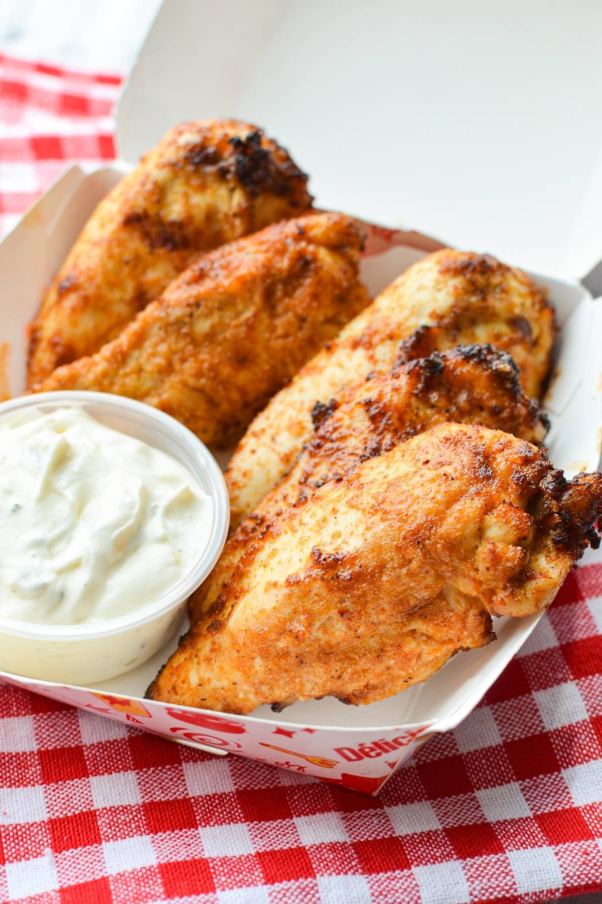 A take out box with plain chicken tenders inside.