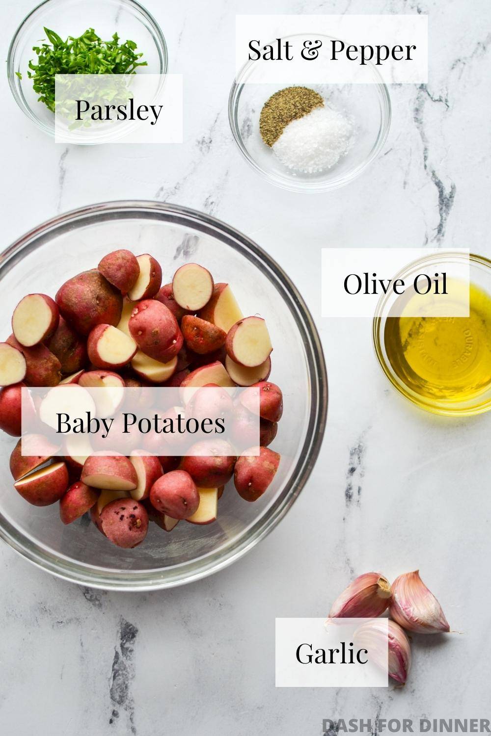 The ingredients needed to make baby potatoes, including olive oil, salt, pepper, garlic, and parsley.