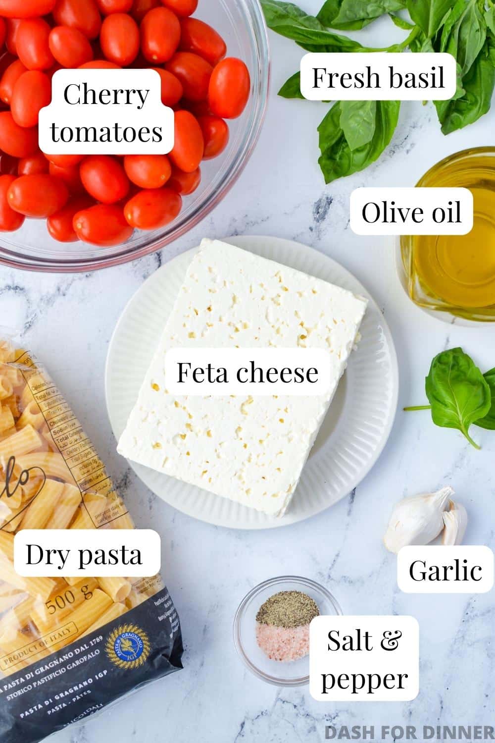The ingredients needed to make baked feta: feta, tomatoes, basil, olive oil, and pasta.