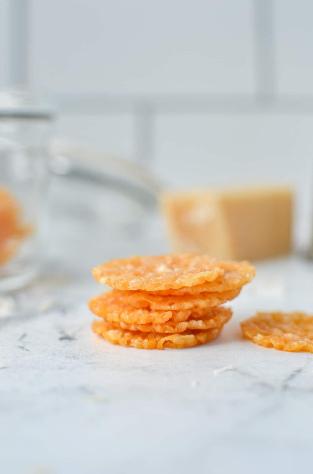 A stack of parmesan crisps on a marble counter.