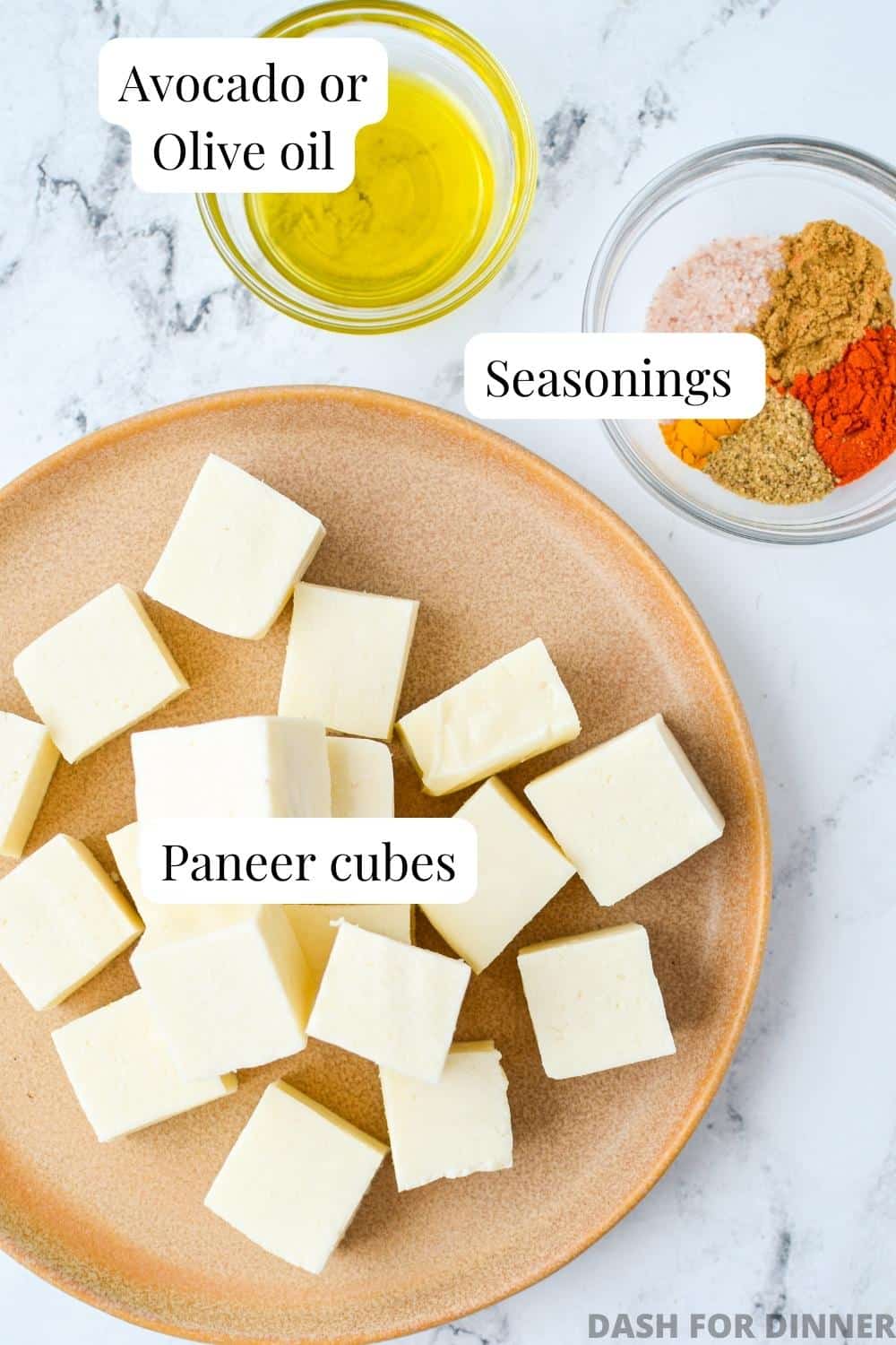 The ingredients needed to make air fryer paneer: paneer, seasonings, and oil.