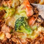 A vegetable casserole with cheese sauce and fried onions.