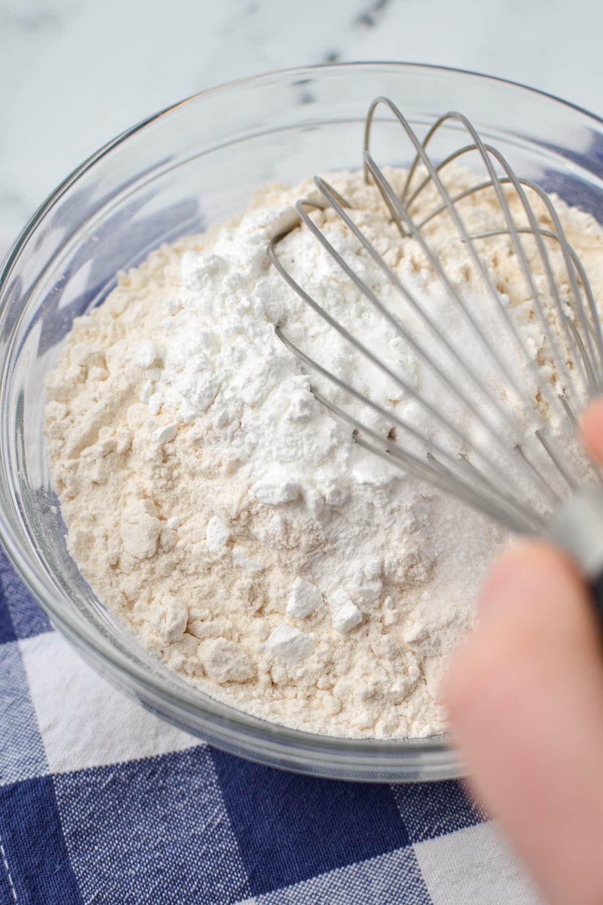 Whisking together flour, baking powder, and salt.