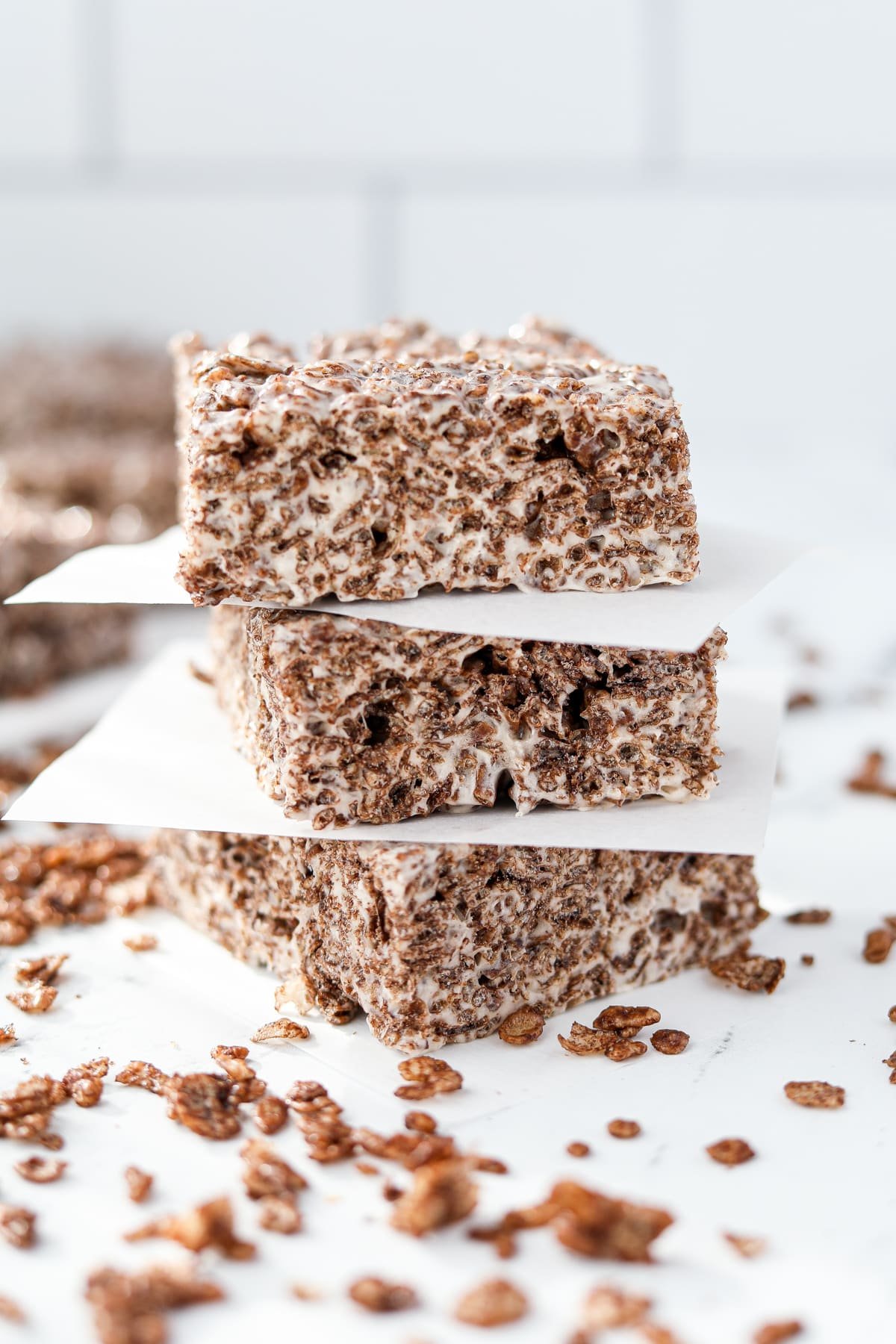 A layer of three cocoa pebbles cereal treats.