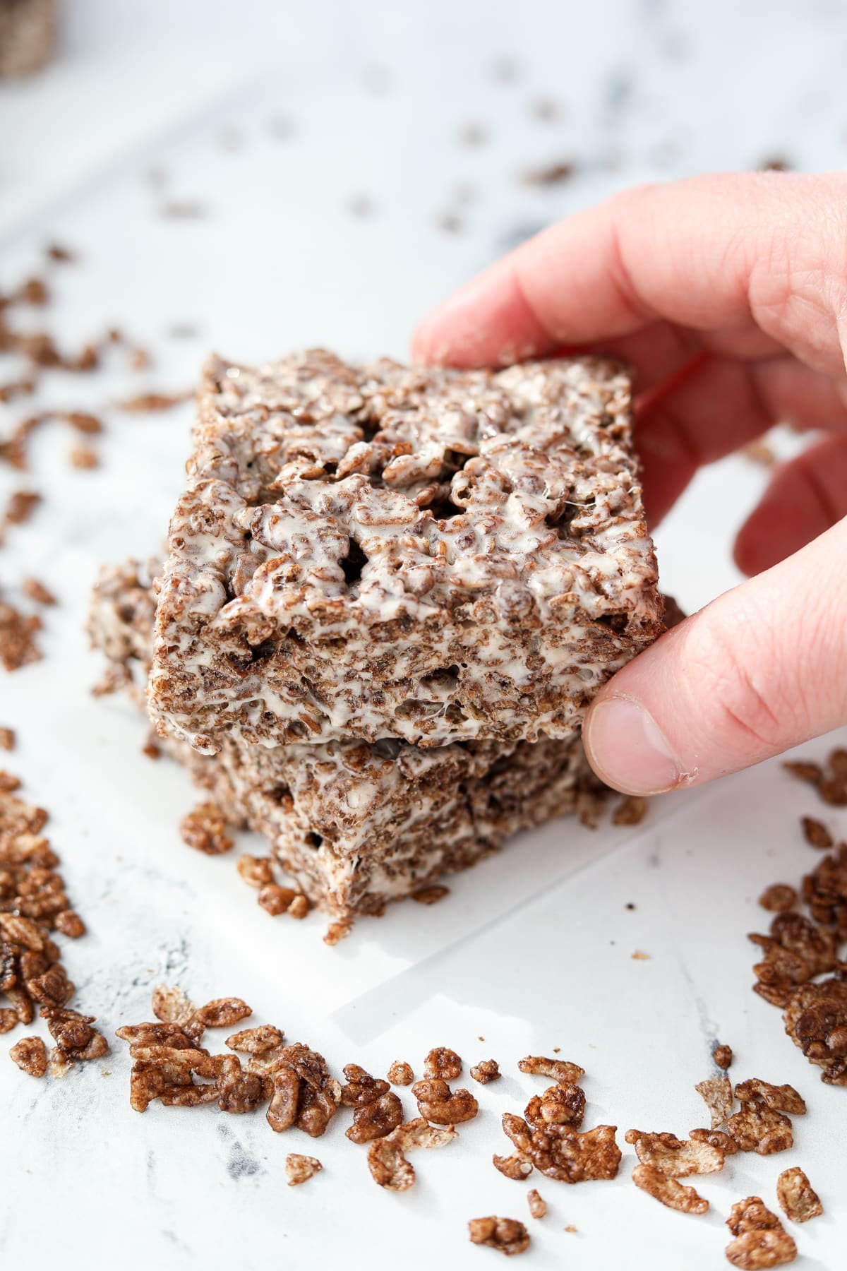 Setting a cereal treat on top of another one.