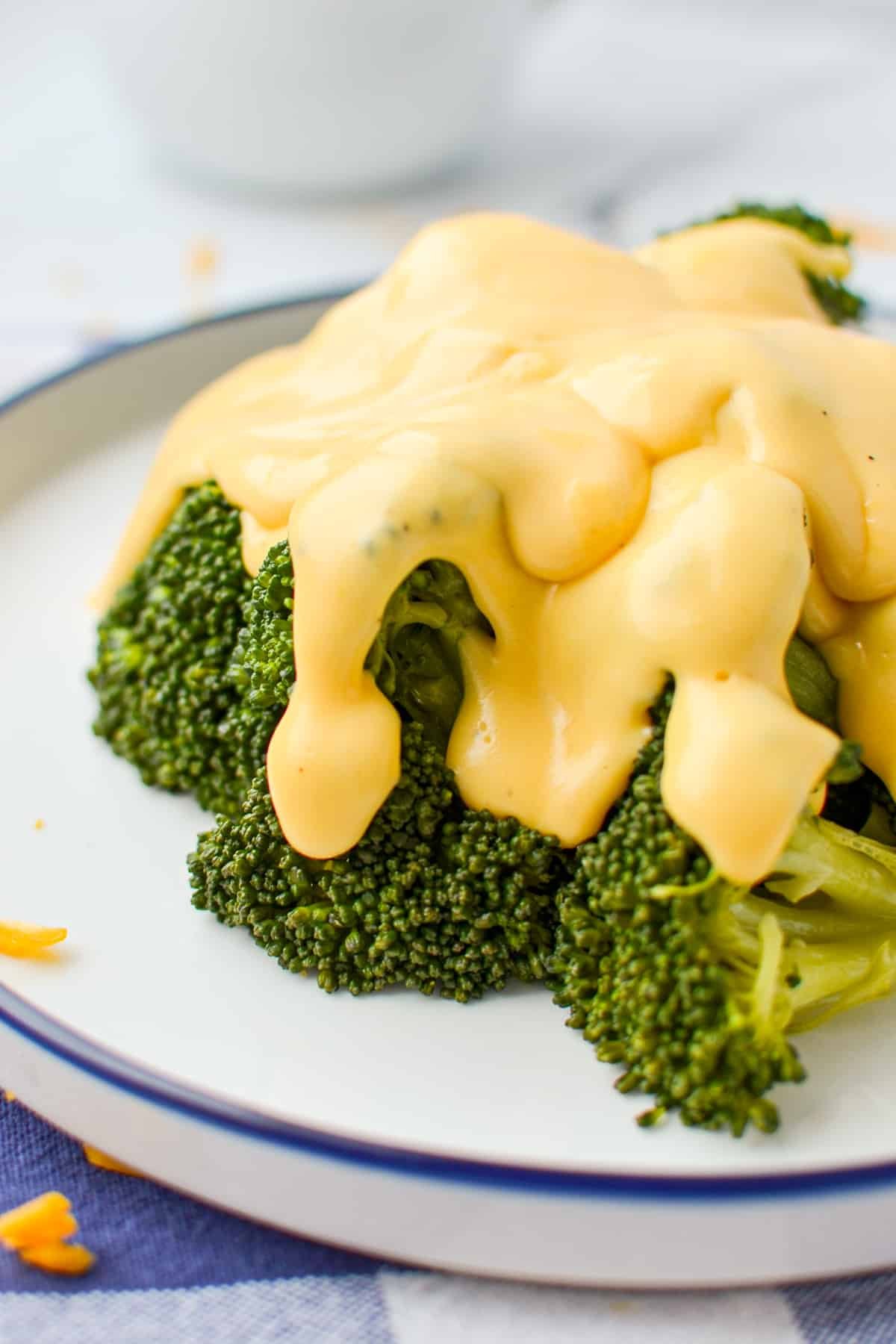 Cheese sauce poured on top of broccoli.