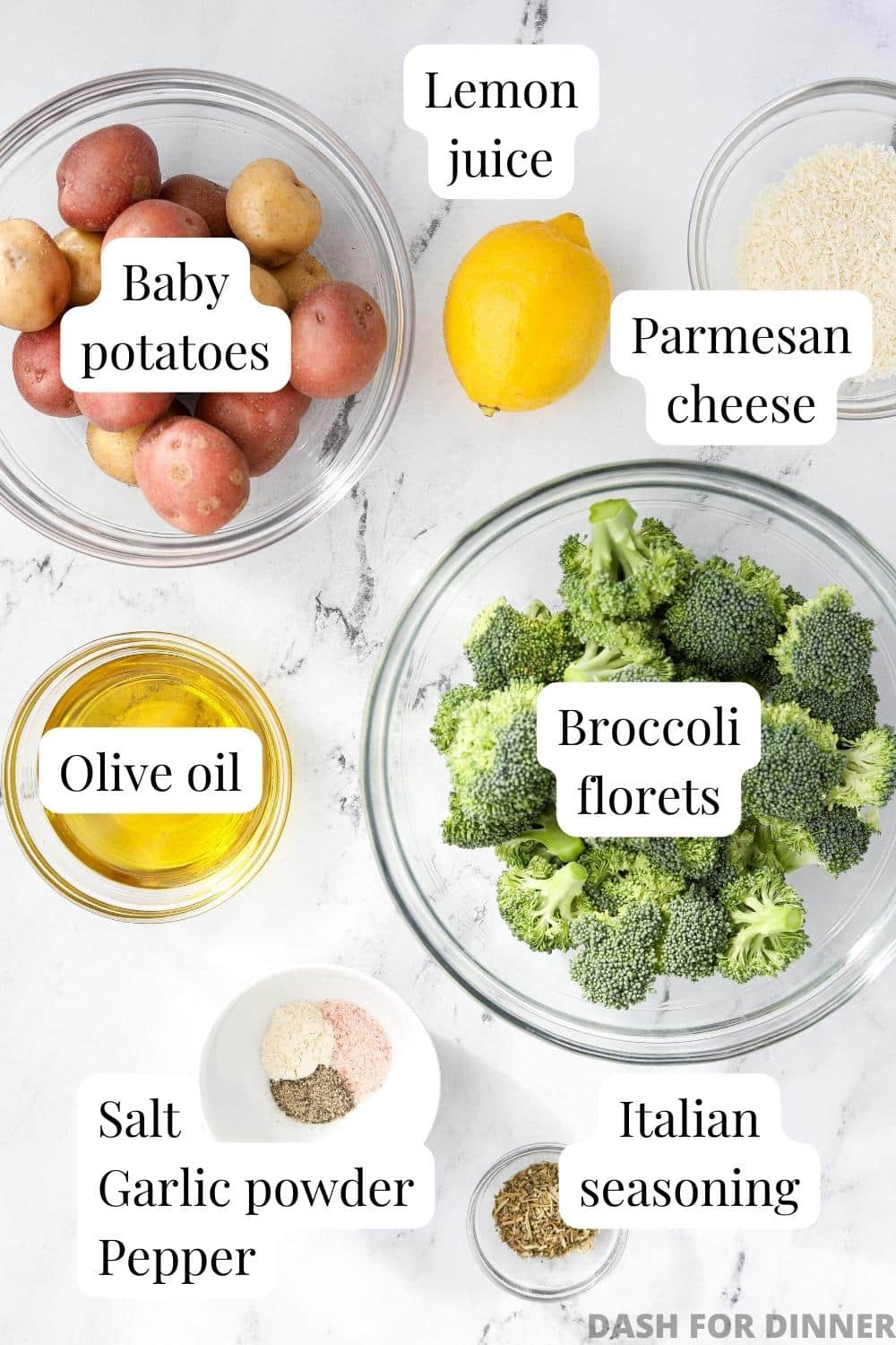 The ingredients needed to make broccoli and potatoes: olive oil, seasonings, lemon juice, and parmesan cheese.