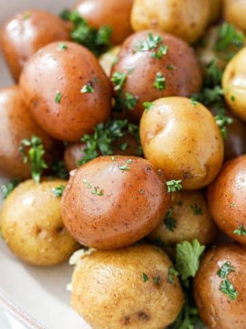 Baby potatoes, buttered and garnished with parsley.