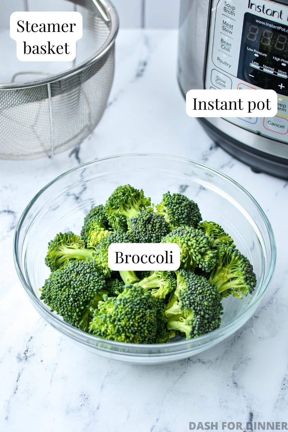 A bowl of fresh broccoli with a steamer basket and an Instant Pot in the background.