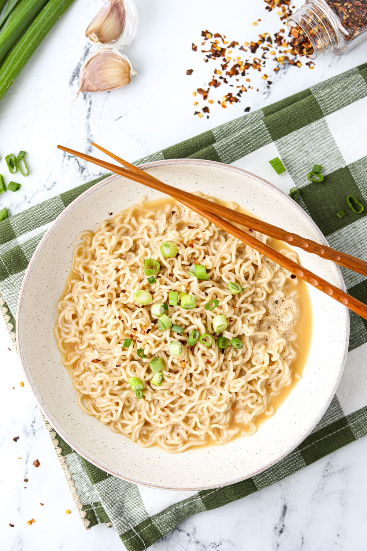 A bowl filled with ramen, with chopsticks on the side.