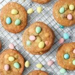 Homemade cookies on a wire rack, studded with Cadbury mini eggs.