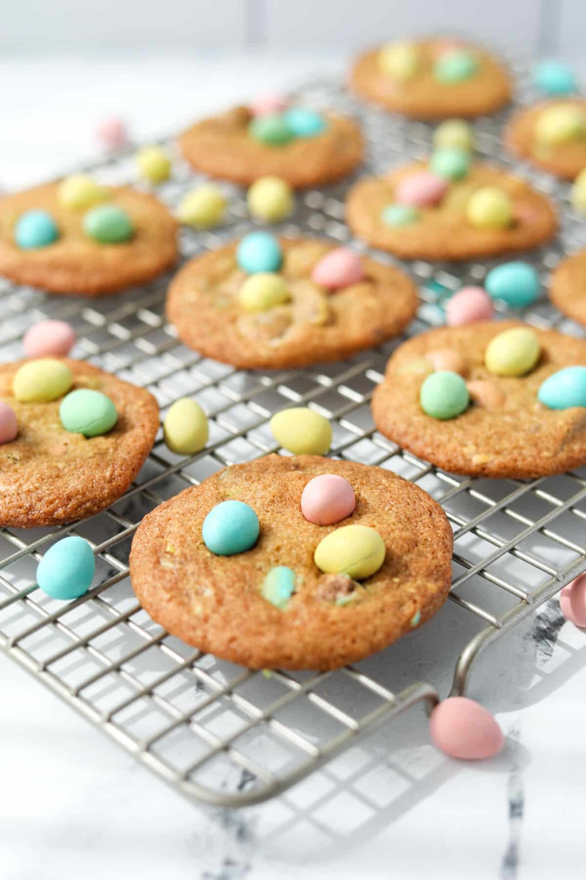 Mini egg cookies cooling on a wire rack.