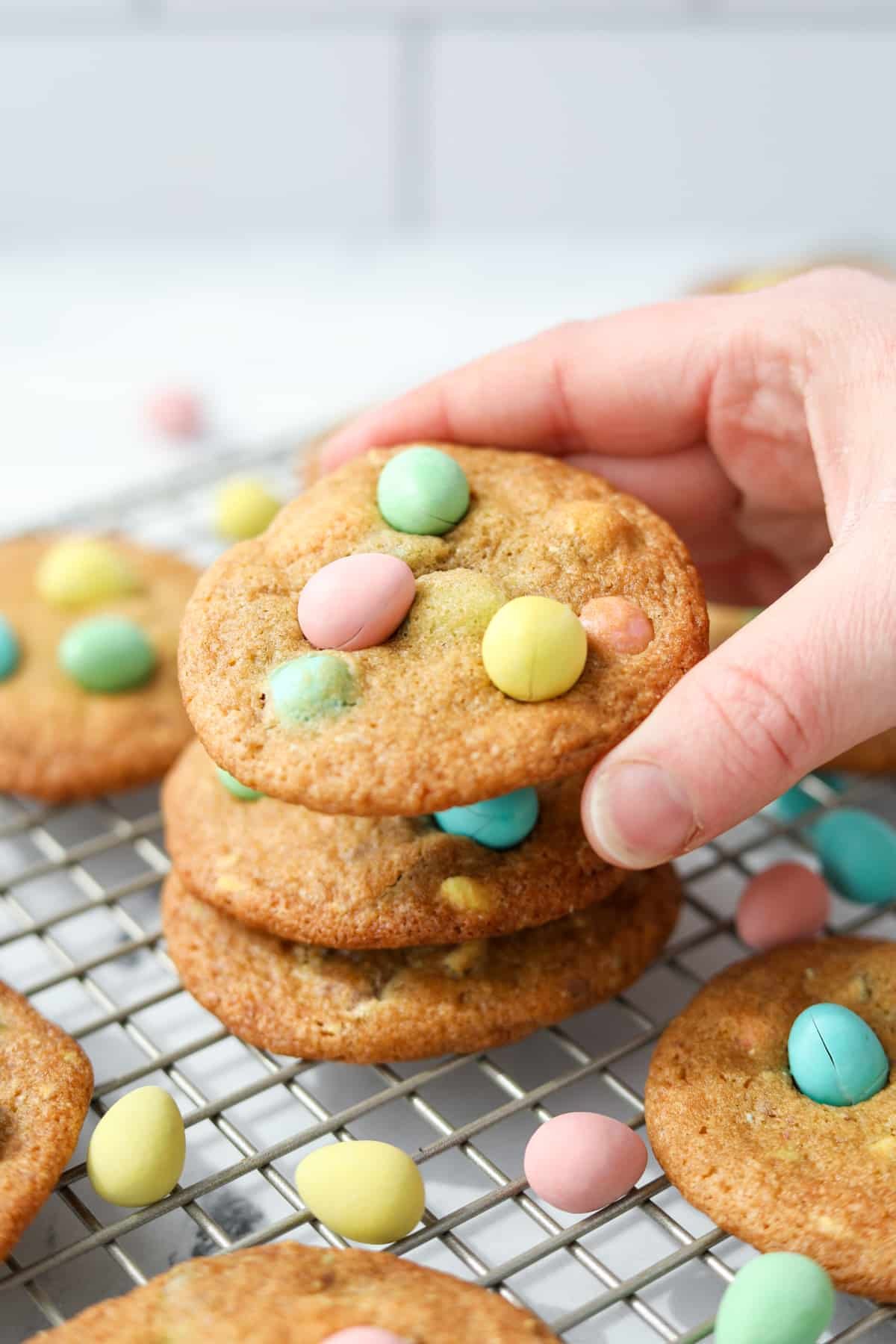 Stacking cookies that are covered with Easter eggs.