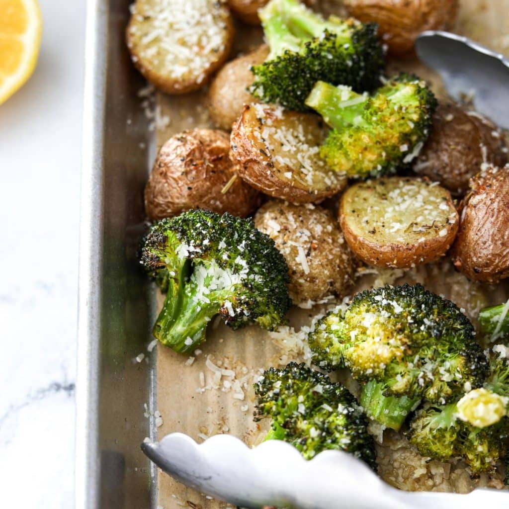 A close up of a pan of roasted broccoli and potatoes.