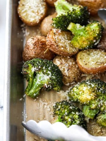 A close up of a pan of roasted broccoli and potatoes.