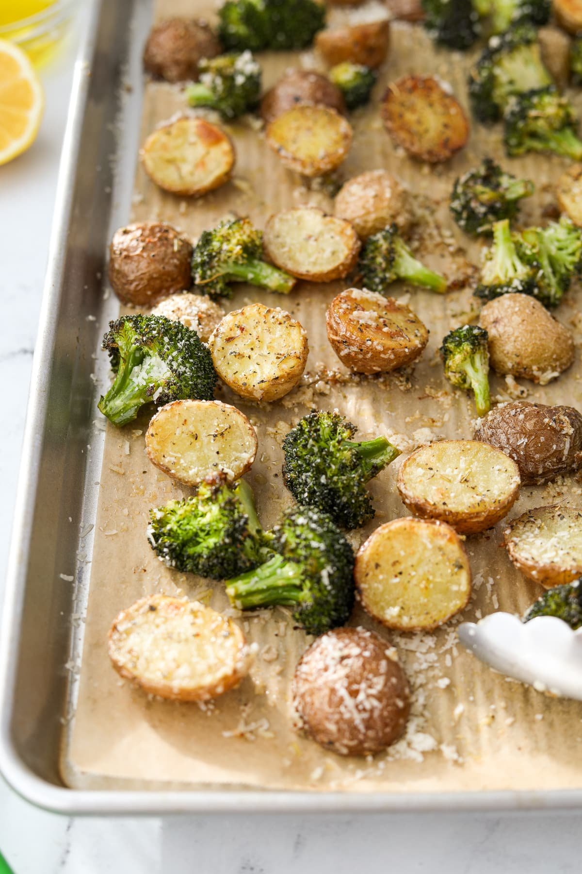 Potatoes and broccoli on a sheet pan.