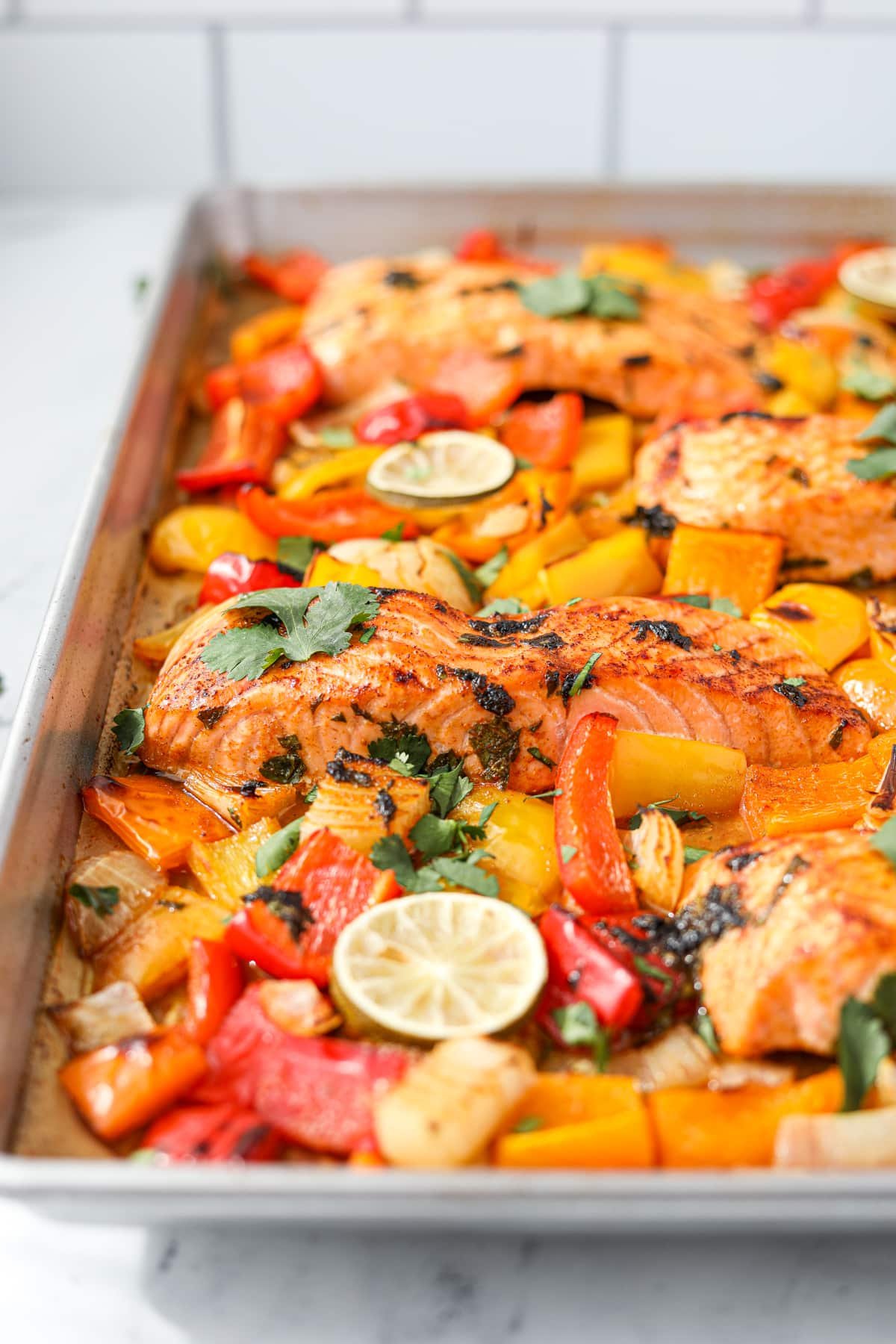 A sheet pan filled with veggies and fish.