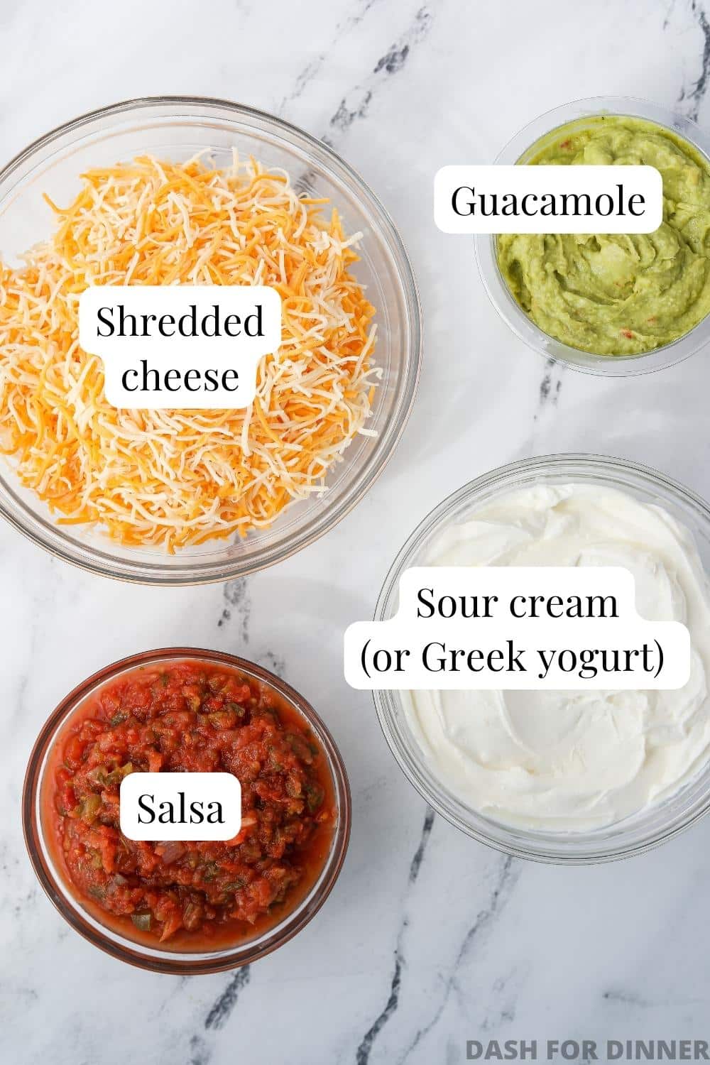 The ingredients needed to make 4 layer dip: sour cream, guacamole, salsa, and shredded cheese.