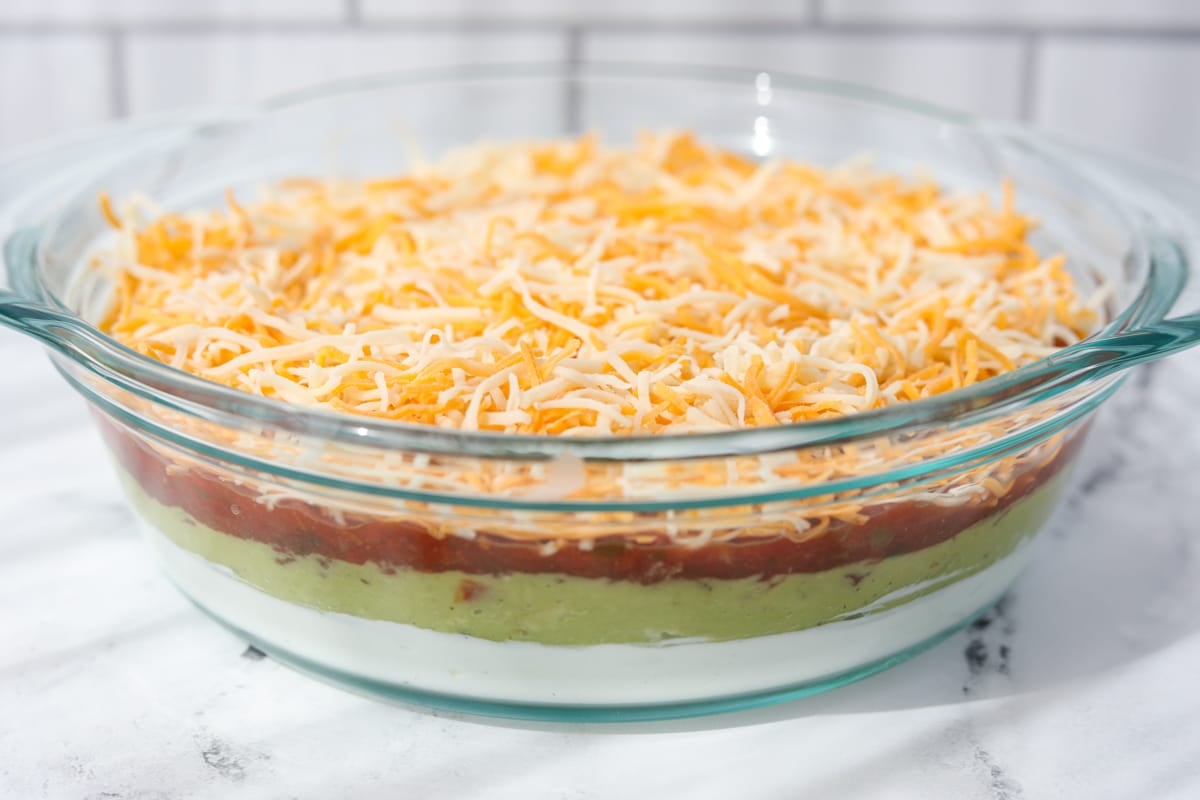 A glass baking dish with a layered dip inside.